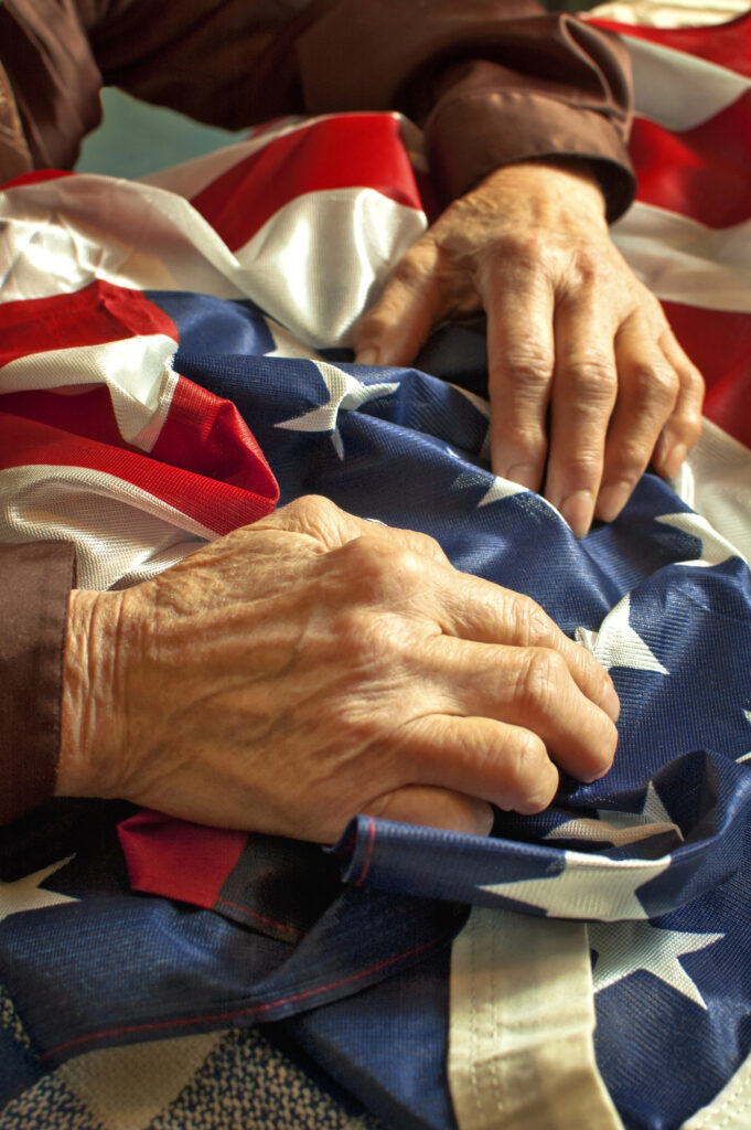 old hands holding an American flag